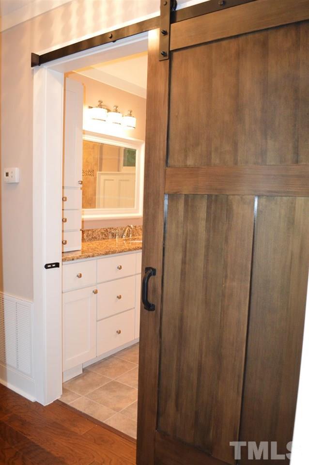 110 Nancy Rhodes Drive Durham, NC 27712 - Photo 20 of 24 a view of an empty room with wooden floor and a window