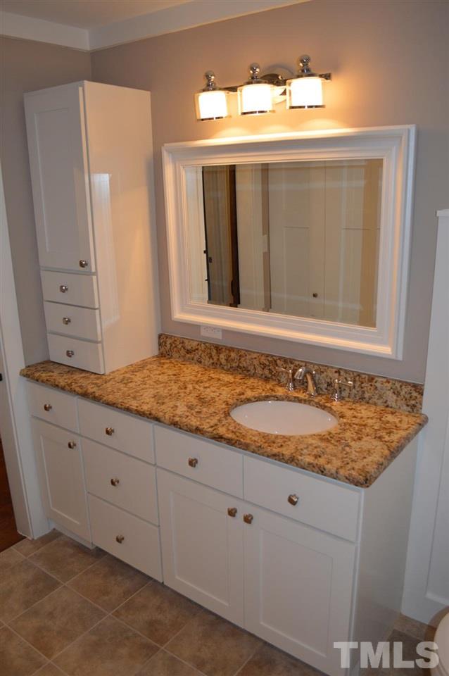 110 Nancy Rhodes Drive Durham, NC 27712 - Photo 21 of 24 a bathroom with a sink and a mirror