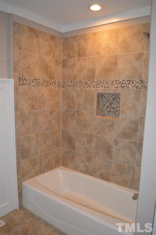 110 Nancy Rhodes Drive Durham, NC 27712 - Photo 23 of 24 a bathroom with a shower and a bathtub
