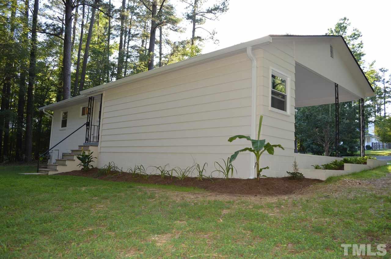 110 Nancy Rhodes Drive Durham, NC 27712 - Photo 6 of 24 a white house that has a tree in front of it