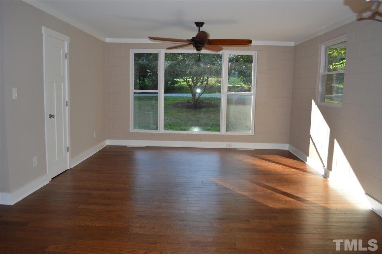 110 Nancy Rhodes Drive Durham, NC 27712 - Photo 9 of 24 a view of an empty room with wooden floor and a window