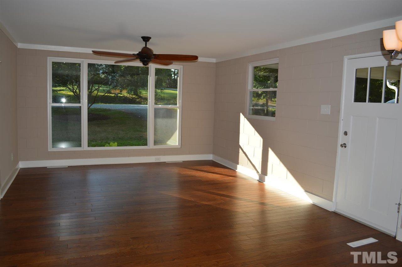 110 Nancy Rhodes Drive Durham, NC 27712 - Photo 10 of 24 a view of an empty room with wooden floor and a window