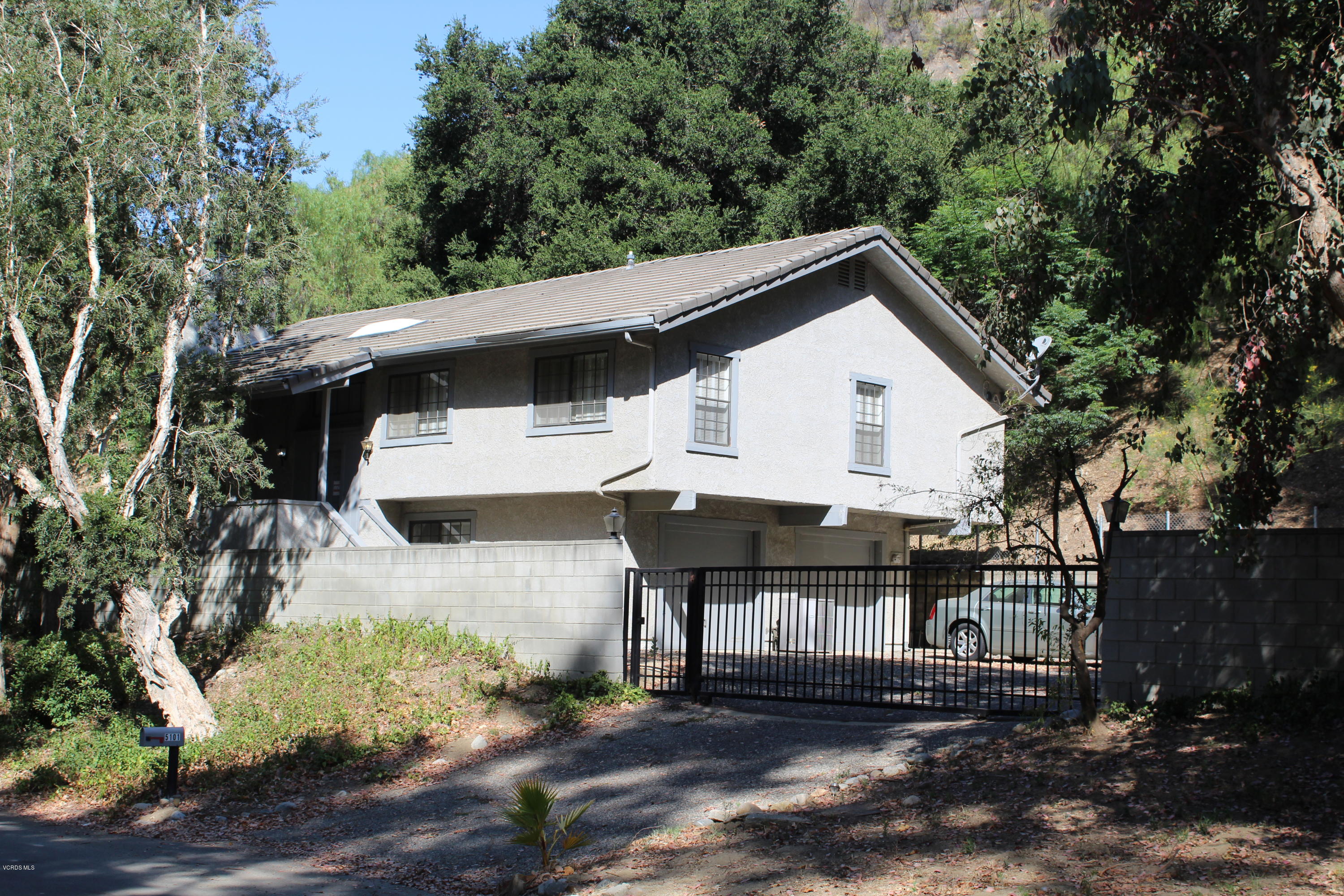5101 Tapo Canyon Road Simi Valley, CA 93063 - Photo 2 of 6 a view of a white house with large windows