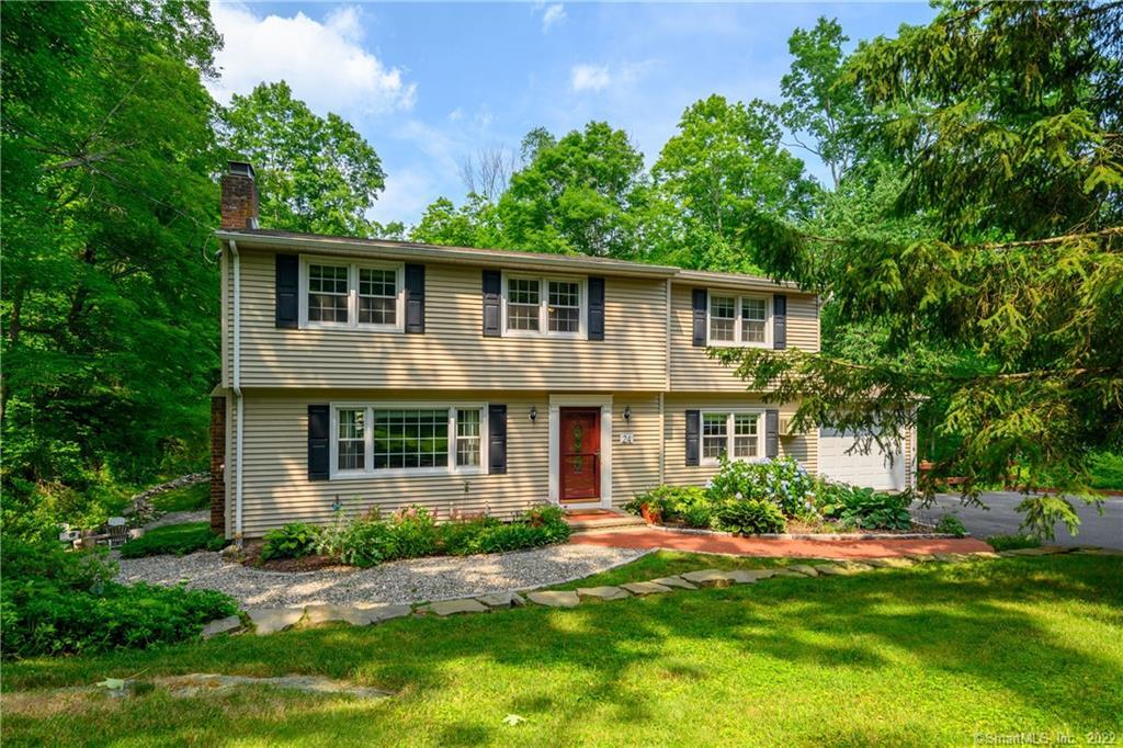 24 Scudder Road Newtown, CT 06470 - Photo 1 of 1 a front view of a house with a yard and potted plants
