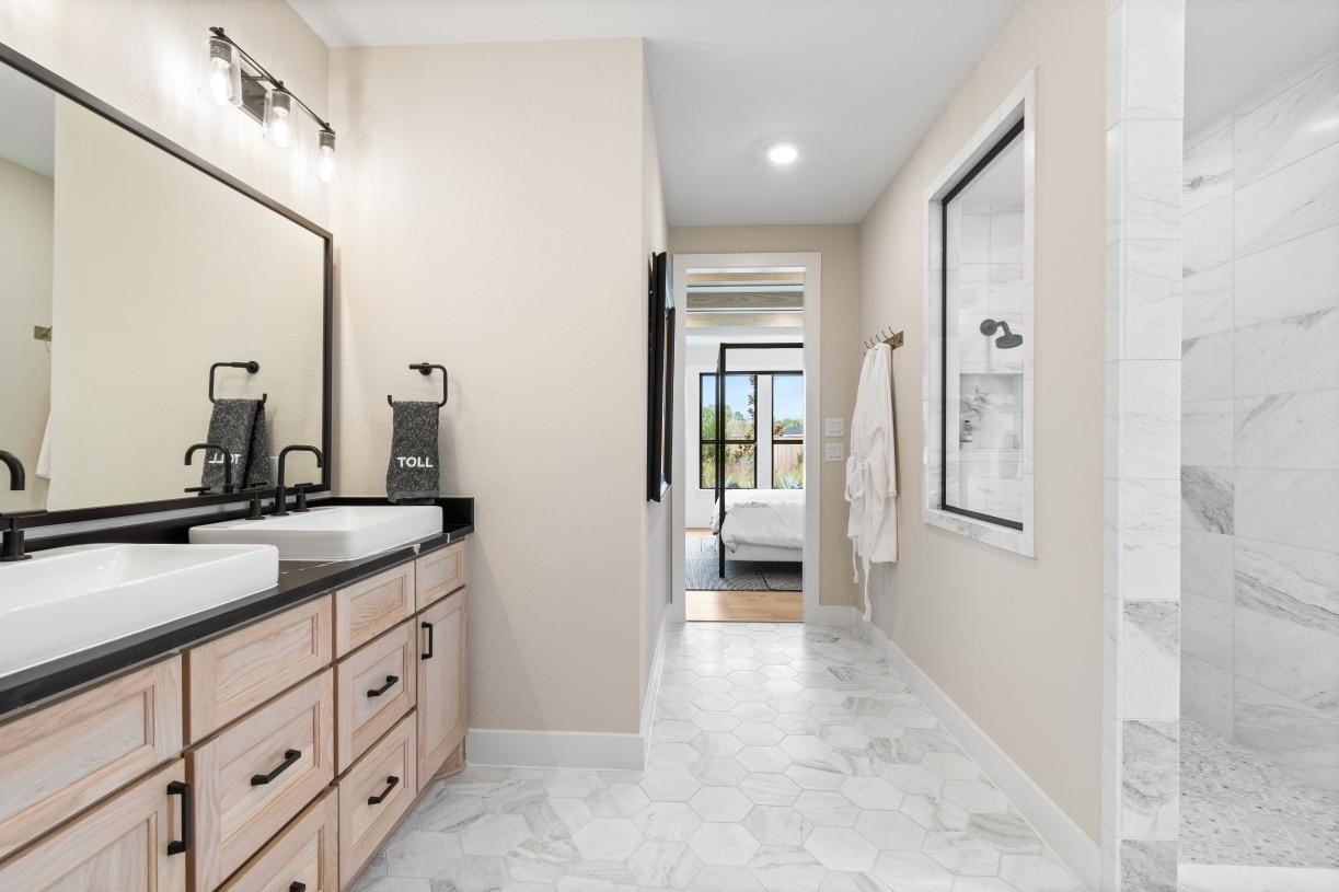 7902 Oakside Court Fulshear, TX 77441 - Photo 9 of 12 a spacious bathroom with a double vanity sink a mirror and shower