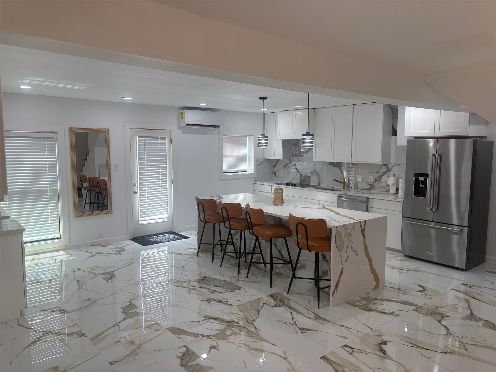 1820 North MacGregor Way Houston, TX 77023 - Photo 18 of 35 a kitchen with stainless steel appliances a refrigerator a sink a stove a dining table and chairs