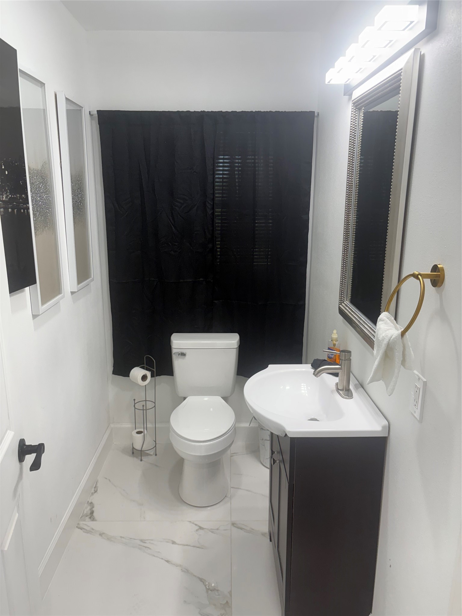 1820 North MacGregor Way Houston, TX 77023 - Photo 21 of 35 a bathroom with a sink a toilet a mirror and shower curtain