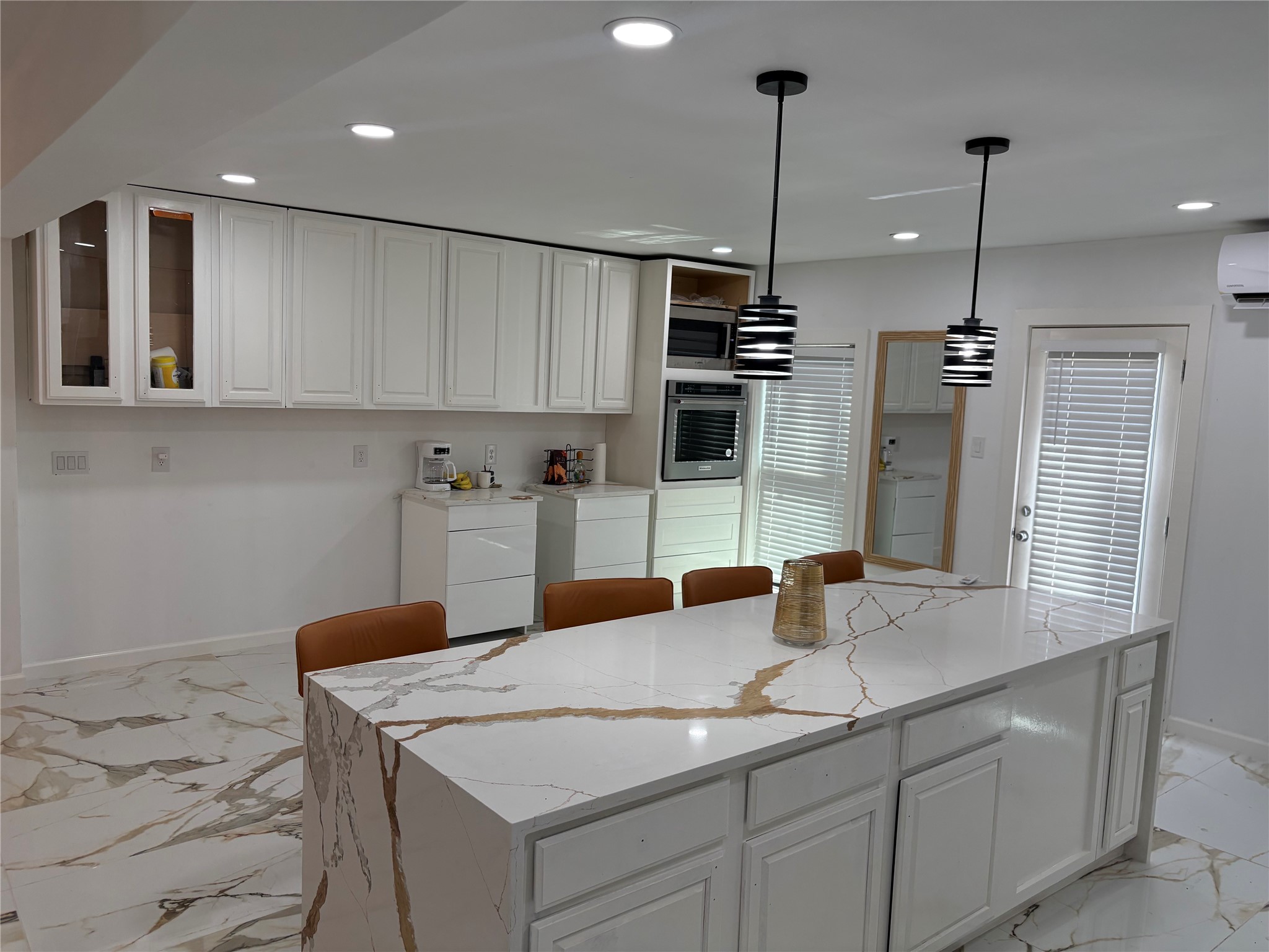1820 North MacGregor Way Houston, TX 77023 - Photo 22 of 35 a kitchen with stainless steel appliances kitchen island granite countertop a sink a microwave and refrigerator