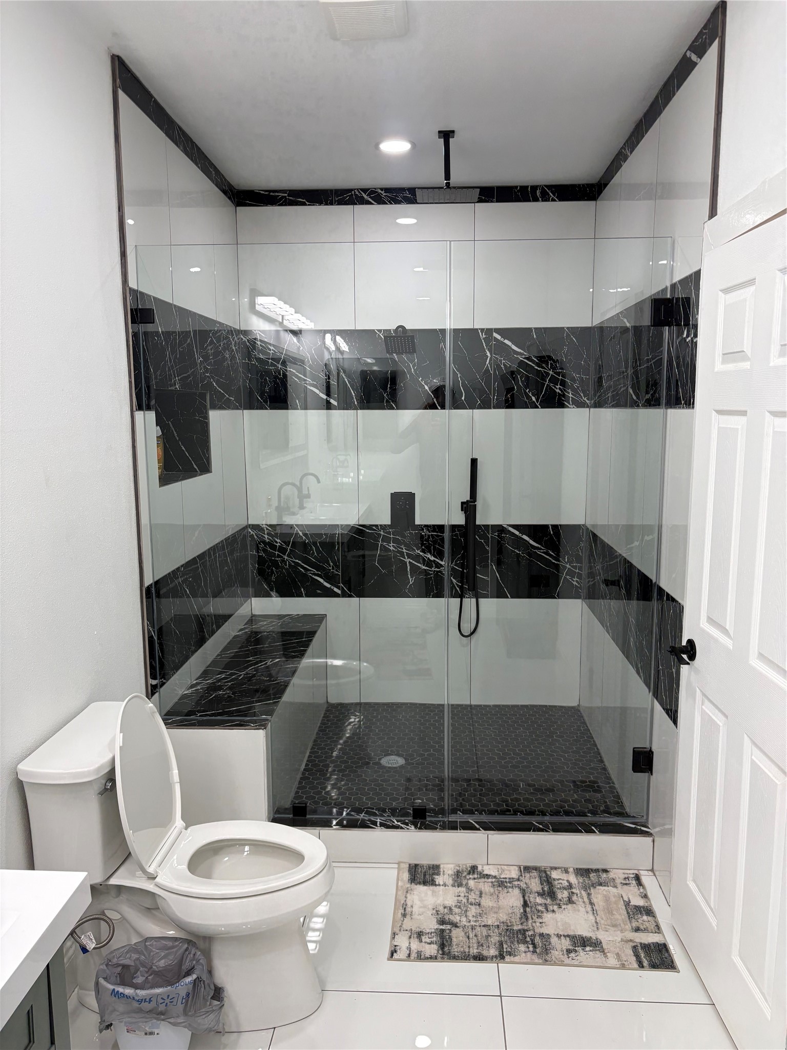 1820 North MacGregor Way Houston, TX 77023 - Photo 26 of 35 a bathroom with a sink a toilet a rug and a shower