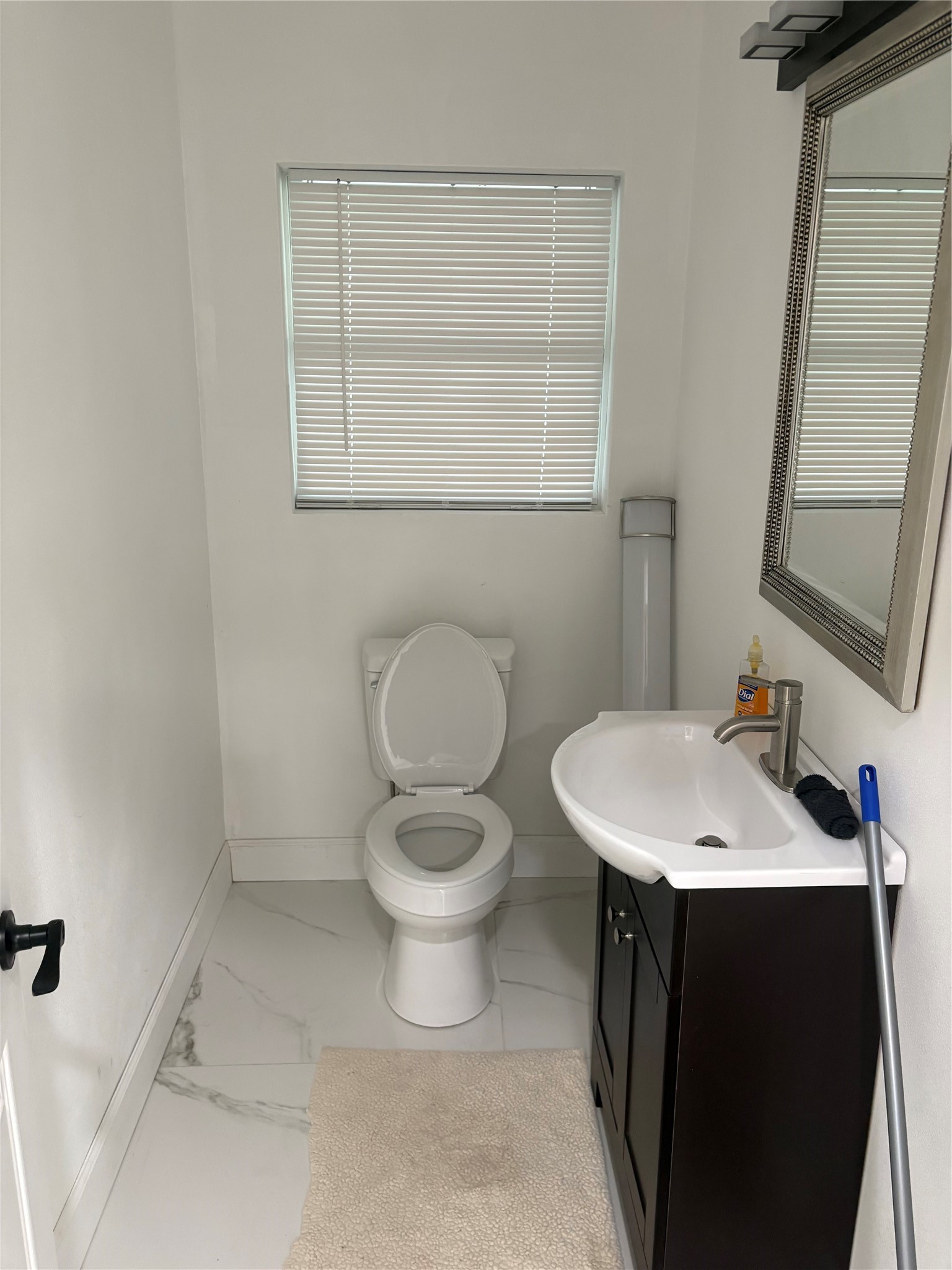 1820 North MacGregor Way Houston, TX 77023 - Photo 7 of 35 a bathroom with a toilet sink and mirror