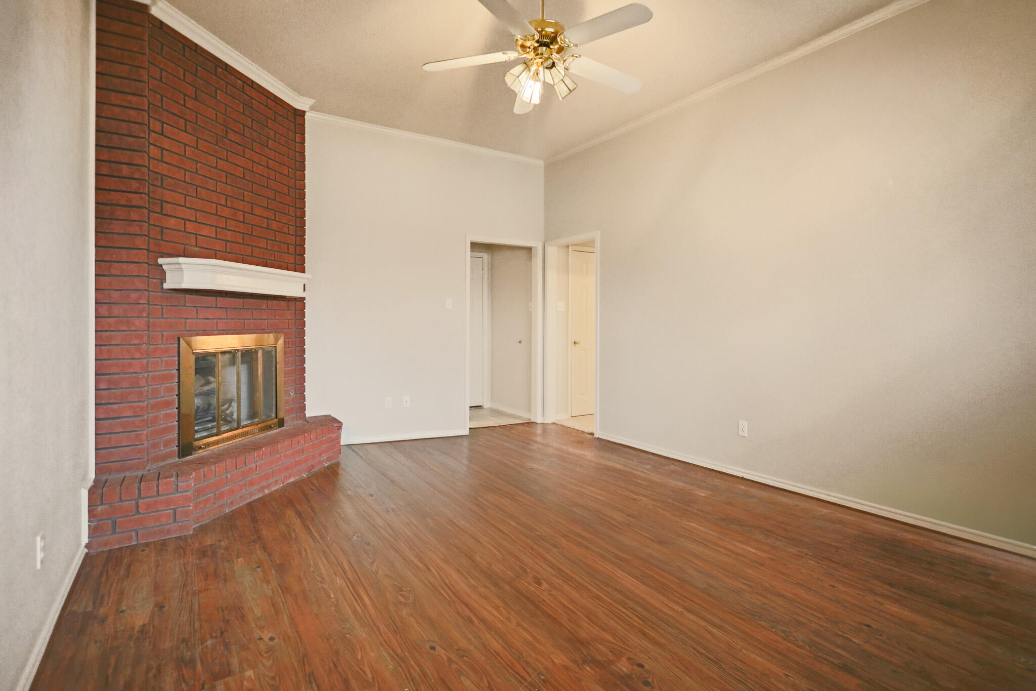 2214 94th Street Lubbock, TX 79423 - Photo 11 of 41 a view of an empty room with wooden floor and a window