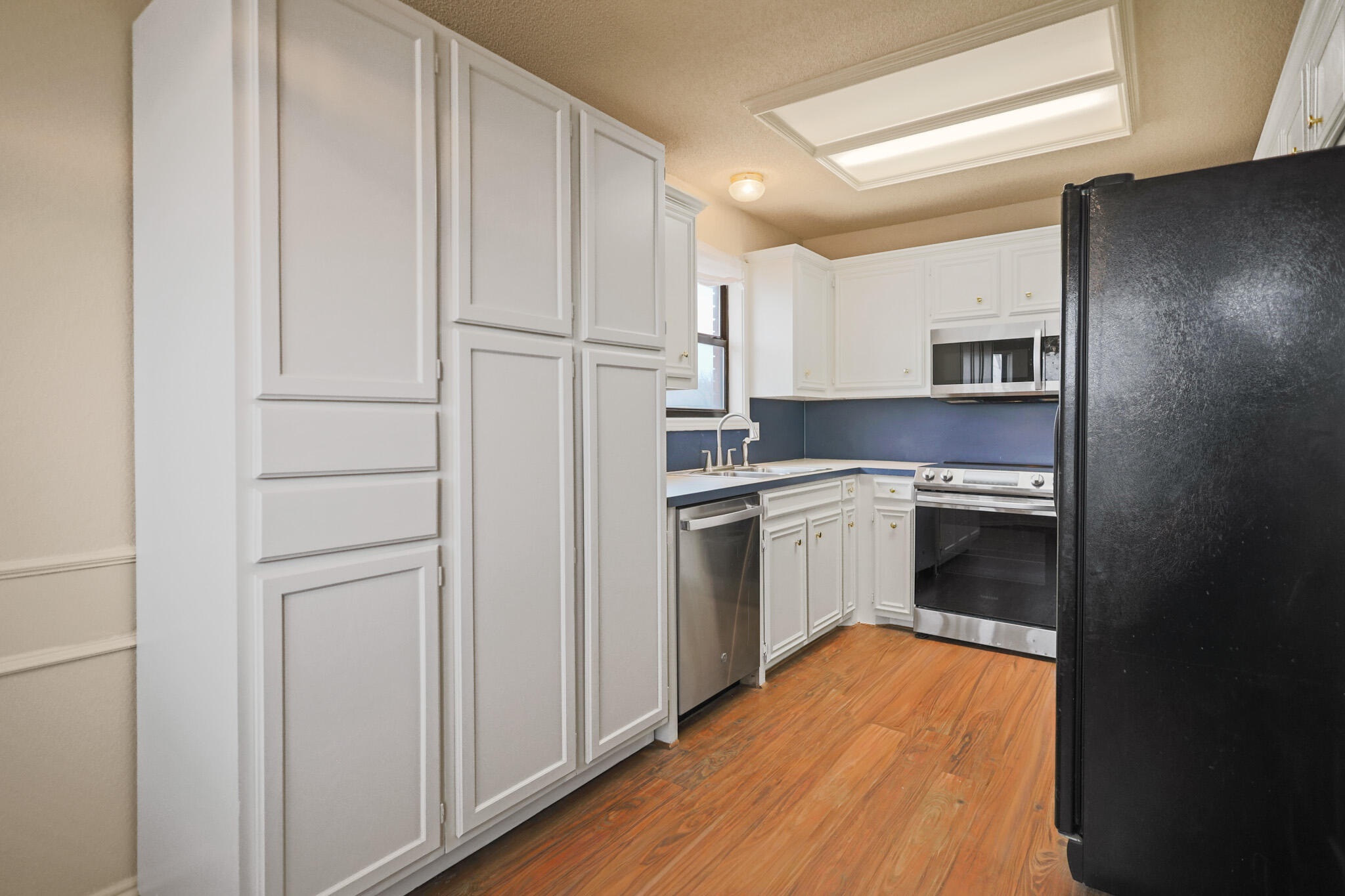 2214 94th Street Lubbock, TX 79423 - Photo 13 of 41 a kitchen with a refrigerator stove and a sink