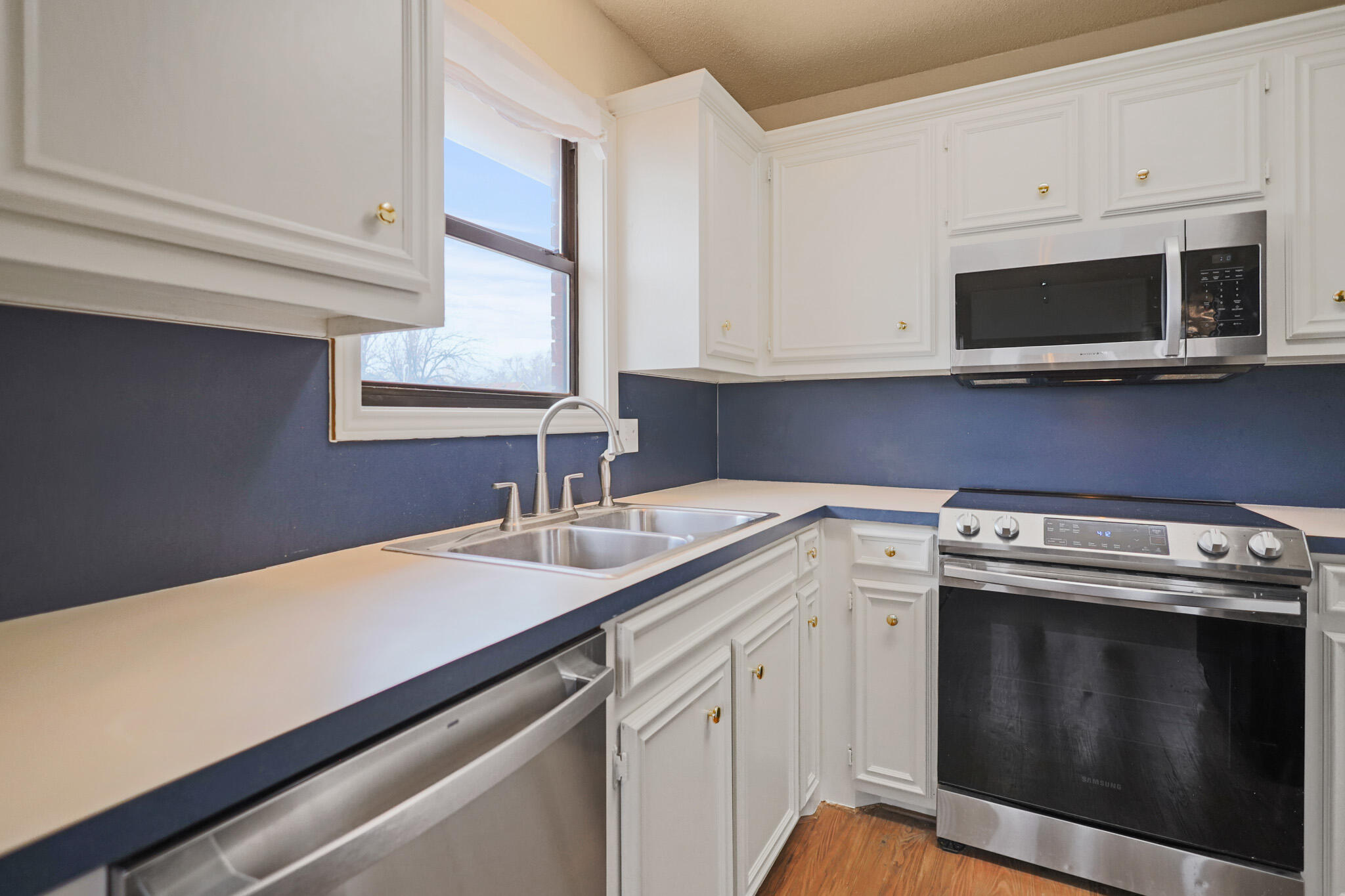 2214 94th Street Lubbock, TX 79423 - Photo 15 of 41 a kitchen with a sink stove and microwave
