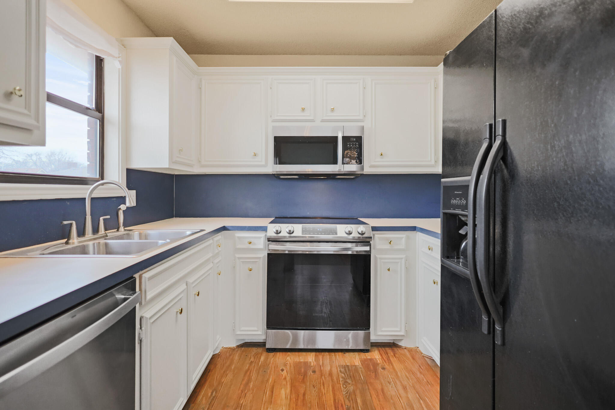 2214 94th Street Lubbock, TX 79423 - Photo 17 of 41 a kitchen with a sink stove and refrigerator