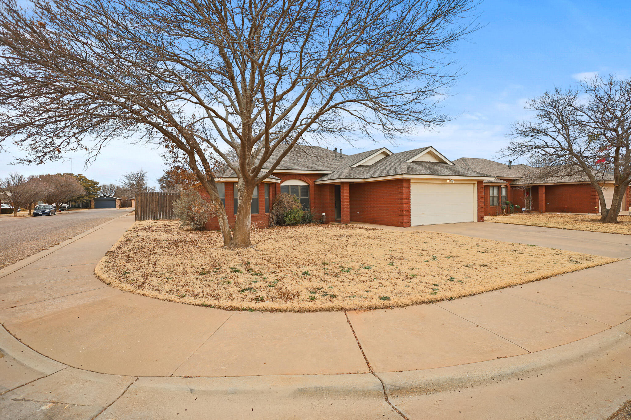 2214 94th Street Lubbock, TX 79423 - Photo 2 of 41 a view of white house with a yard covered with snow