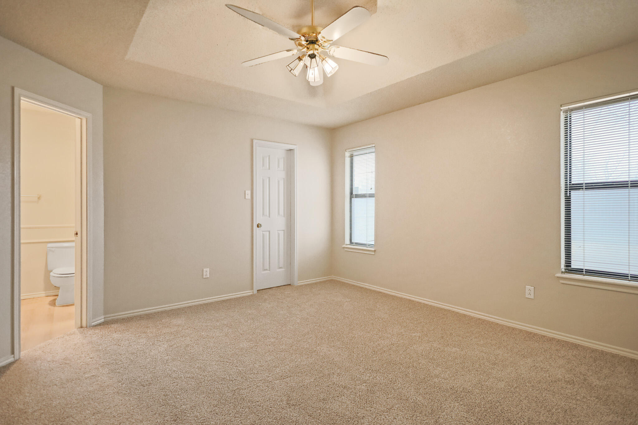 2214 94th Street Lubbock, TX 79423 - Photo 22 of 41 an empty room with windows and fan