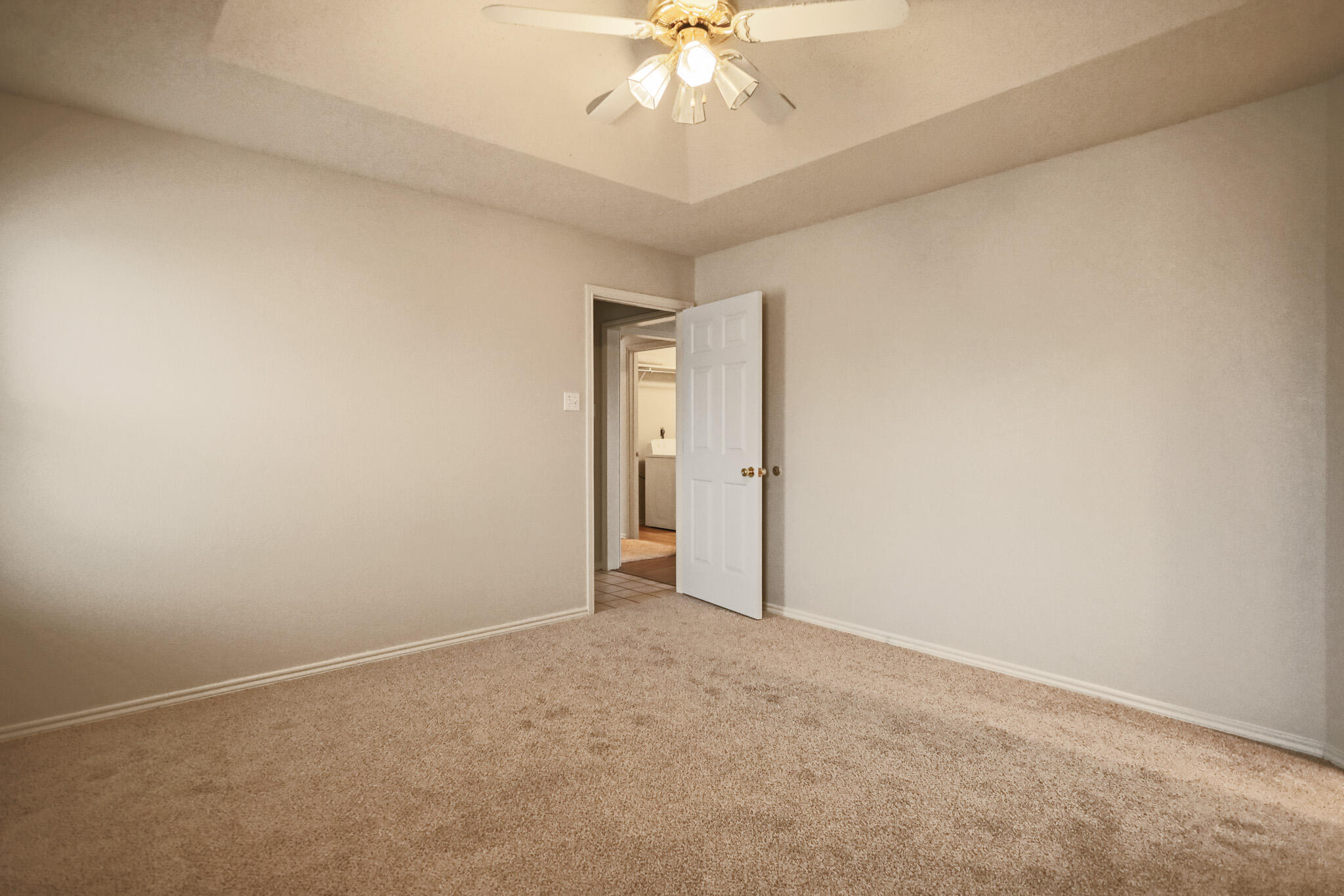 2214 94th Street Lubbock, TX 79423 - Photo 24 of 41 an empty room with a chandelier fan and windows