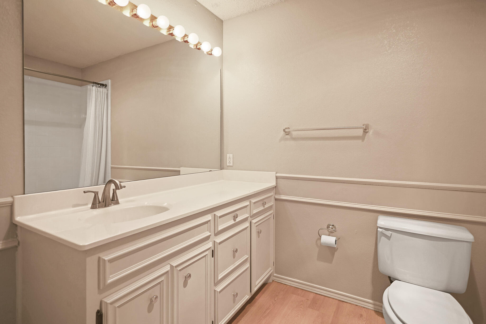 2214 94th Street Lubbock, TX 79423 - Photo 28 of 41 a bathroom with a sink a toilet and a mirror