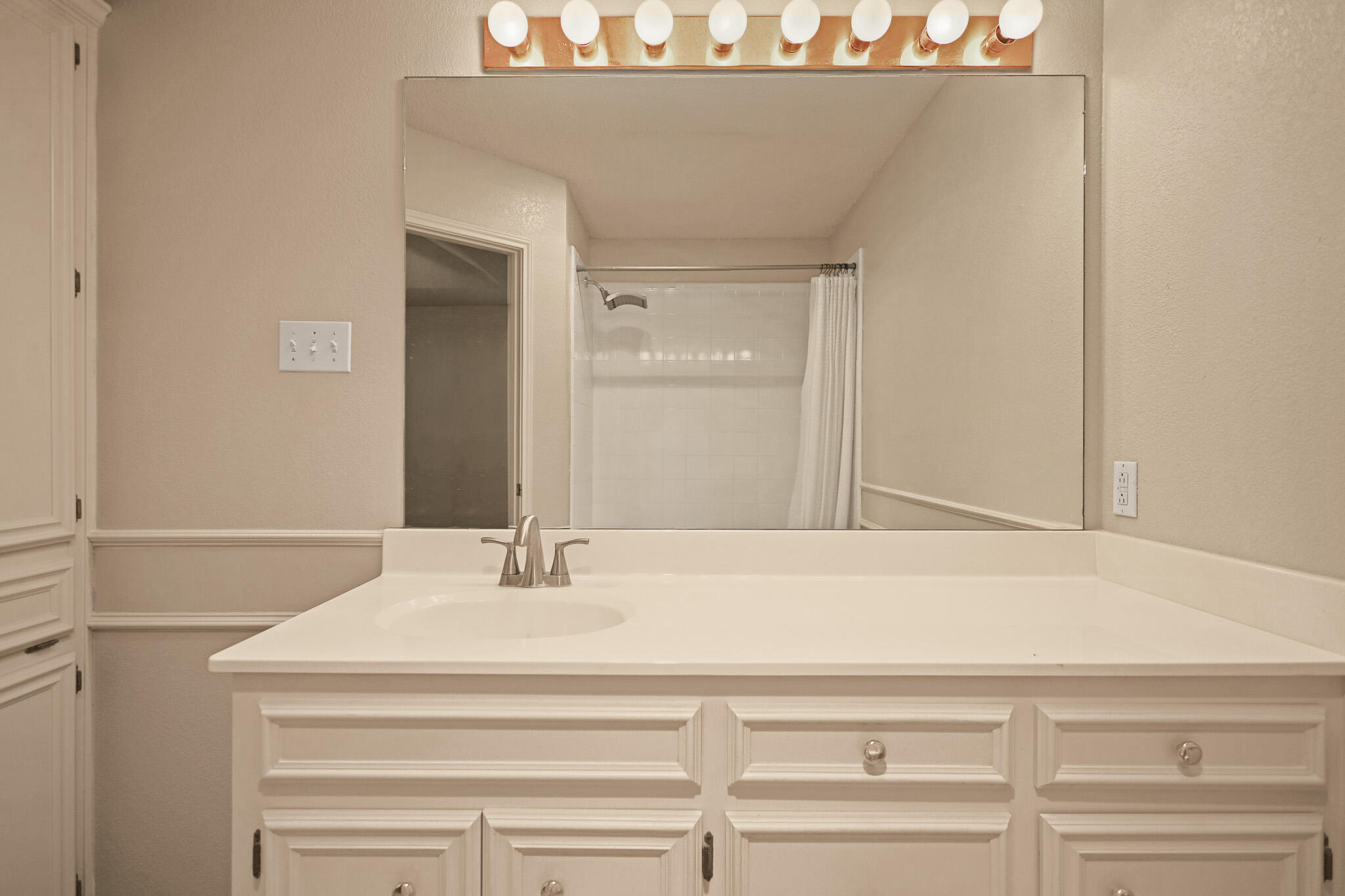 2214 94th Street Lubbock, TX 79423 - Photo 30 of 41 a bathroom with a sink and a mirror