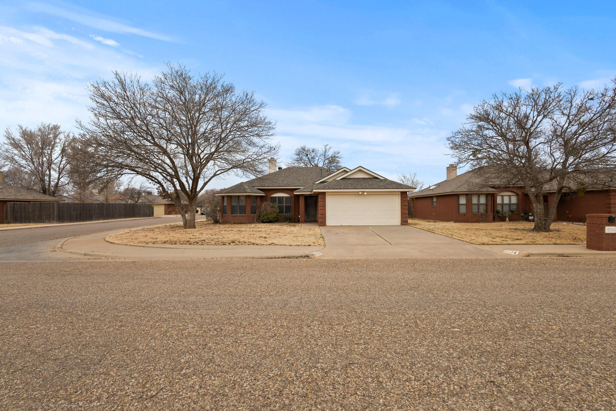 2214 94th Street Lubbock, TX 79423 - Photo 3 of 41 a front view of a house with a yard and garage