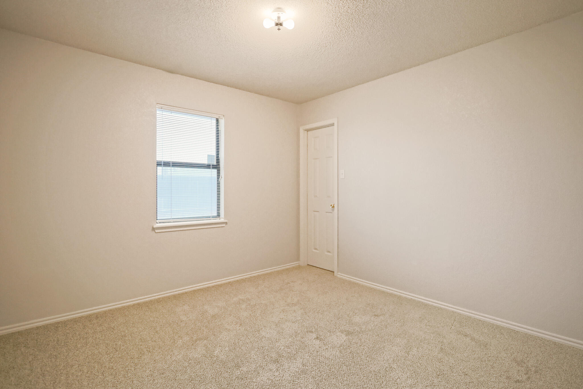 2214 94th Street Lubbock, TX 79423 - Photo 32 of 41 an empty room with a window