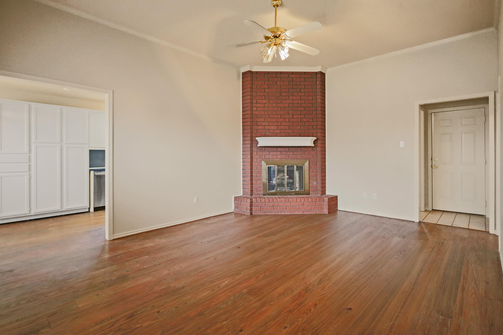 2214 94th Street Lubbock, TX 79423 - Photo 6 of 41 an empty room with wooden floor chandelier and windows