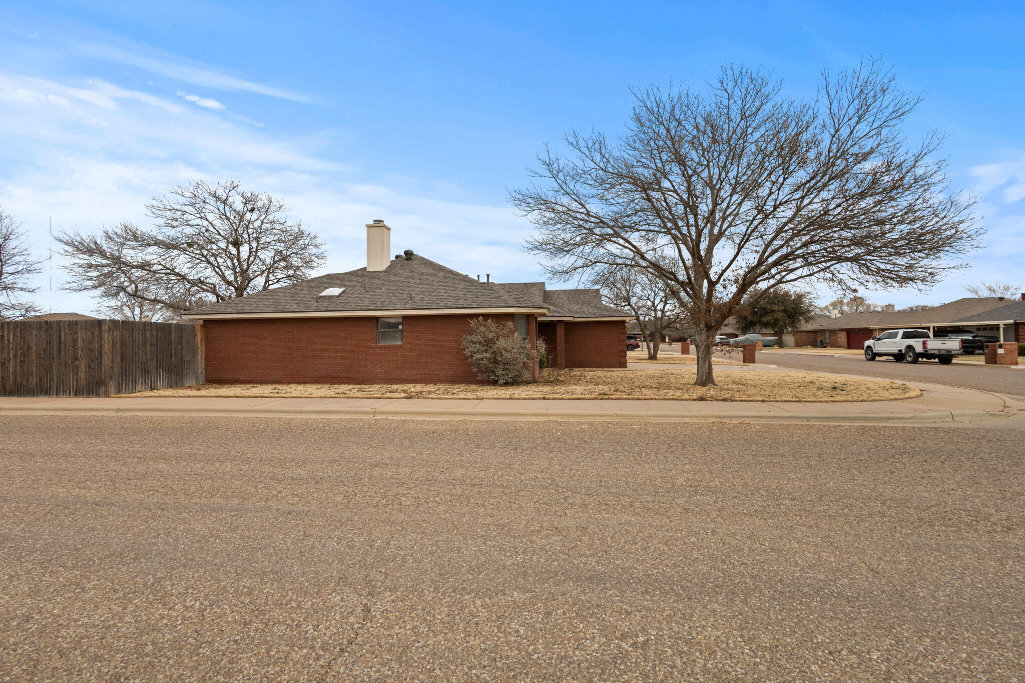 2214 94th Street Lubbock, TX 79423 - Photo 8 of 41 a front view of a house with a yard and tree s