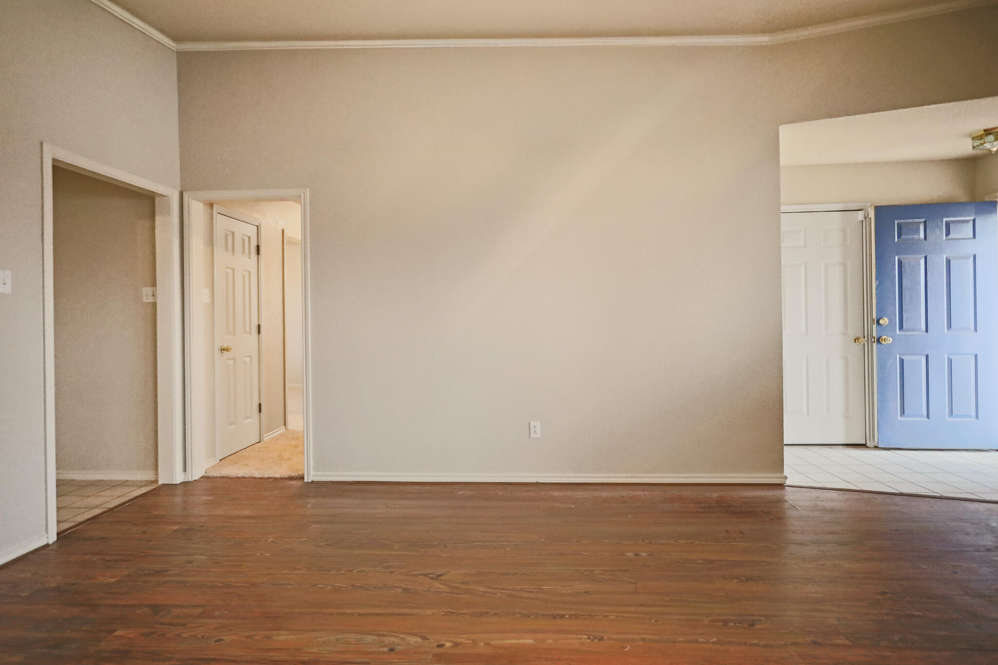 2214 94th Street Lubbock, TX 79423 - Photo 10 of 41 a view of an empty room with wooden floor and a window