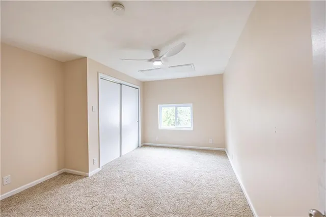 a view of room with a ceiling fan and window