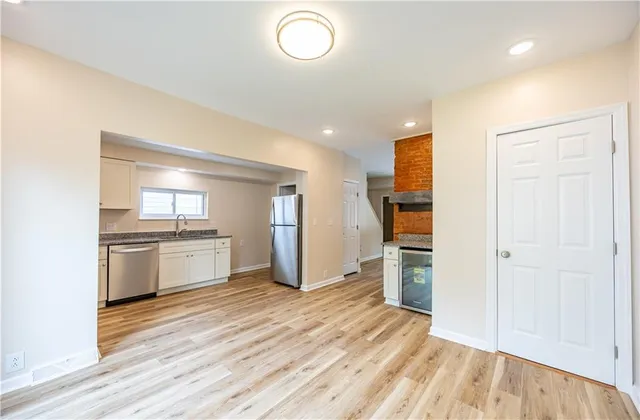 a kitchen with granite countertop a refrigerator and a stove