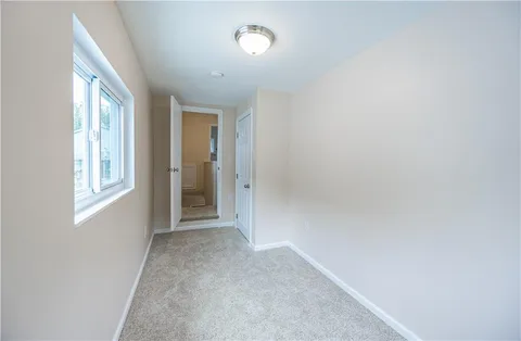 an empty room with windows and closet