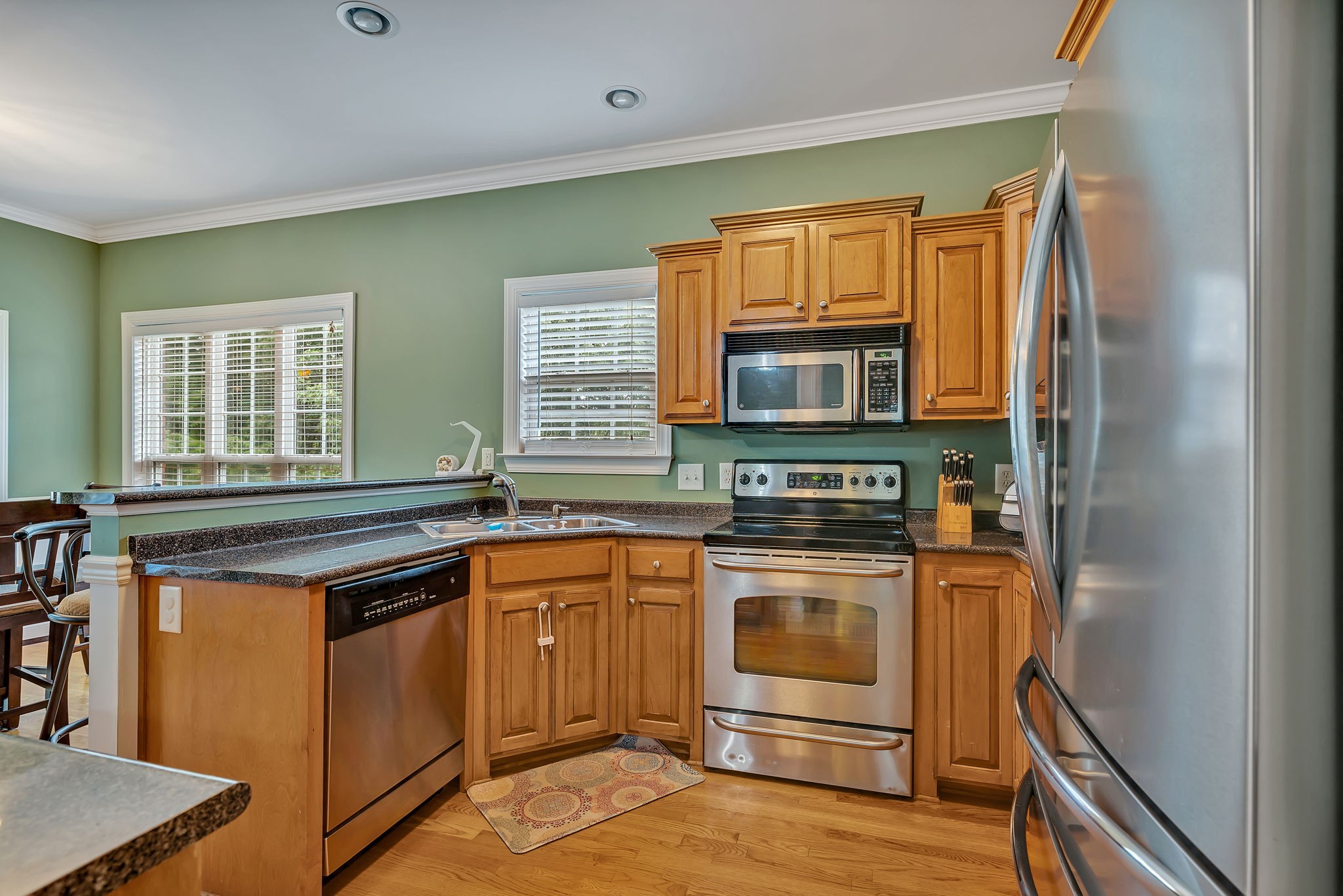 573 Summit Way Mount Juliet, TN 37122 - Photo 11 of 37 a kitchen with stainless steel appliances granite countertop a stove and a microwave