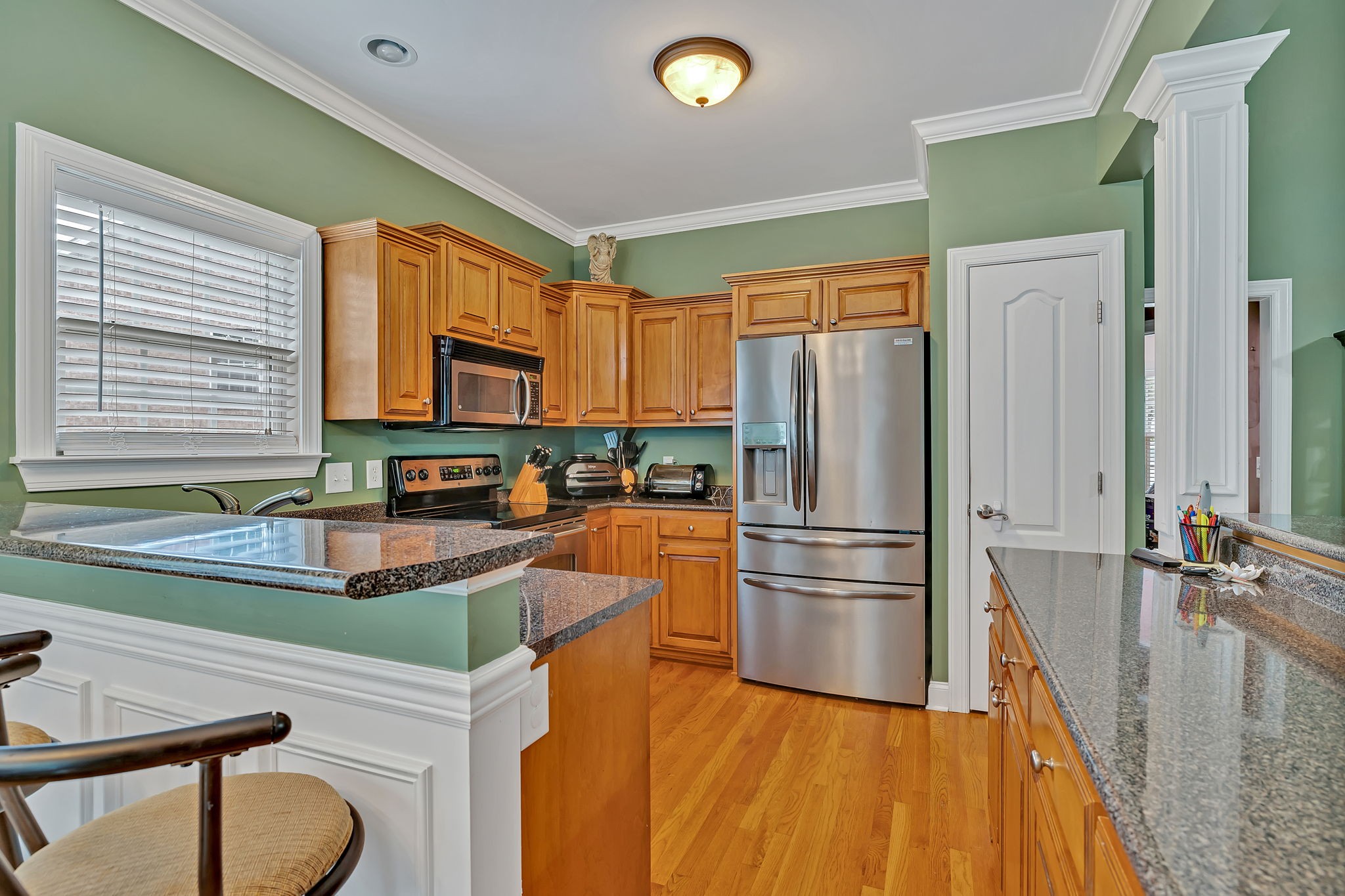 573 Summit Way Mount Juliet, TN 37122 - Photo 10 of 37 a kitchen with granite countertop a refrigerator and a stove top oven