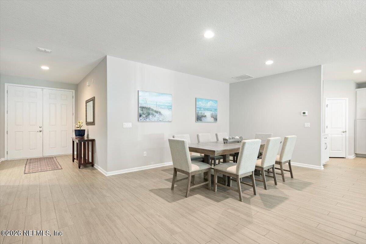 553 Archstone Way St. Augustine, FL 32092 - Photo 11 of 56 a dining room with furniture and wooden floor