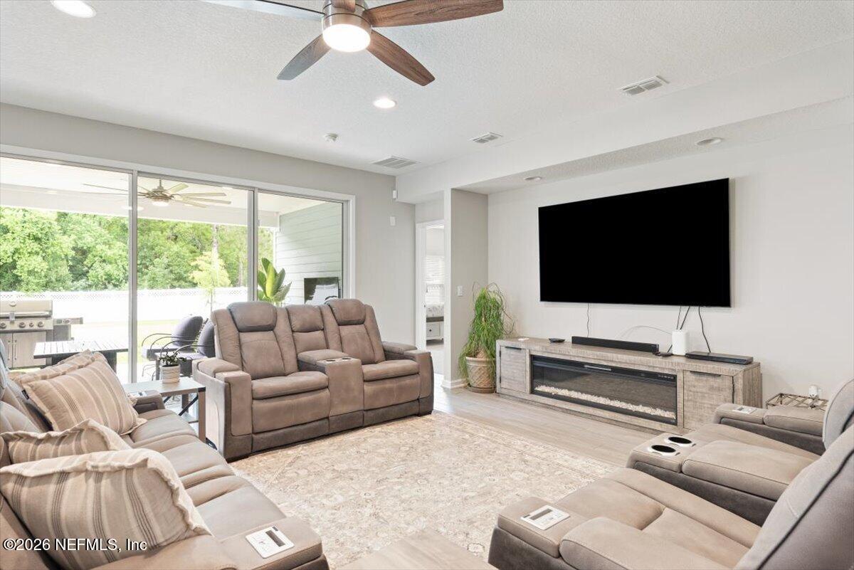 553 Archstone Way St. Augustine, FL 32092 - Photo 19 of 56 a living room with furniture and a flat screen tv
