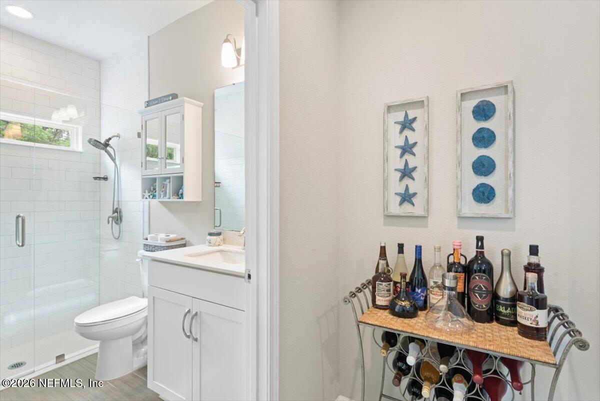553 Archstone Way St. Augustine, FL 32092 - Photo 27 of 56 a bathroom with a sink a toilet and shower curtain
