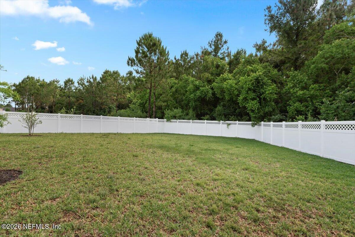 553 Archstone Way St. Augustine, FL 32092 - Photo 38 of 56 a view of yard with swimming pool and trees in the background