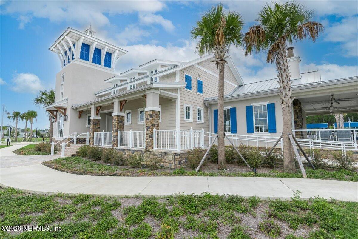553 Archstone Way St. Augustine, FL 32092 - Photo 54 of 56 a front view of a house with a yard and potted plants