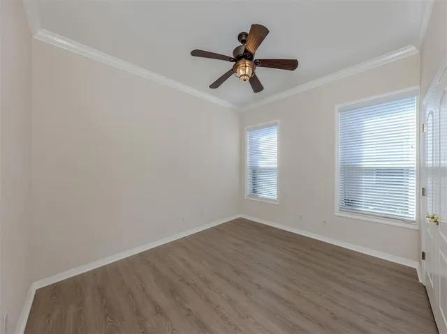 a view of a room with wooden floor and windows