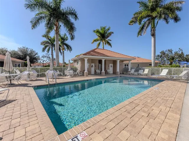 a view of a house with a swimming pool and a patio