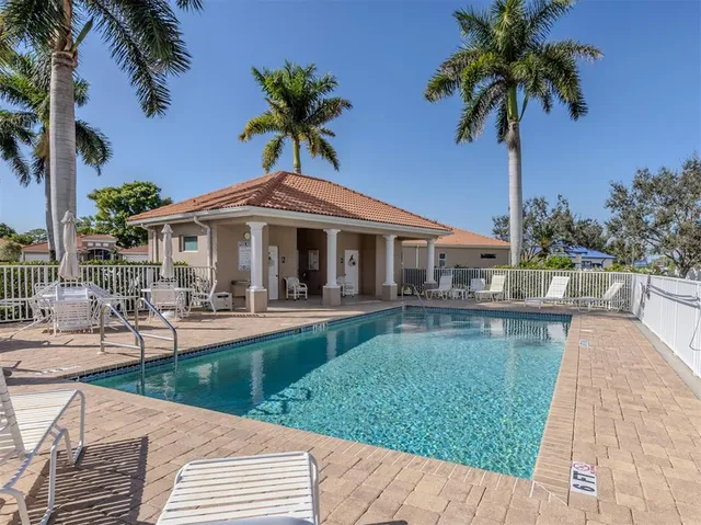 a patio with a table and chairs under an umbrella