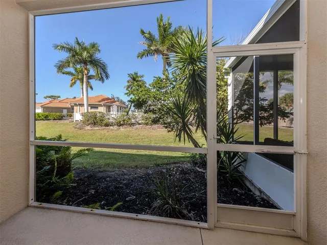 a view of a porch with a table and chairs