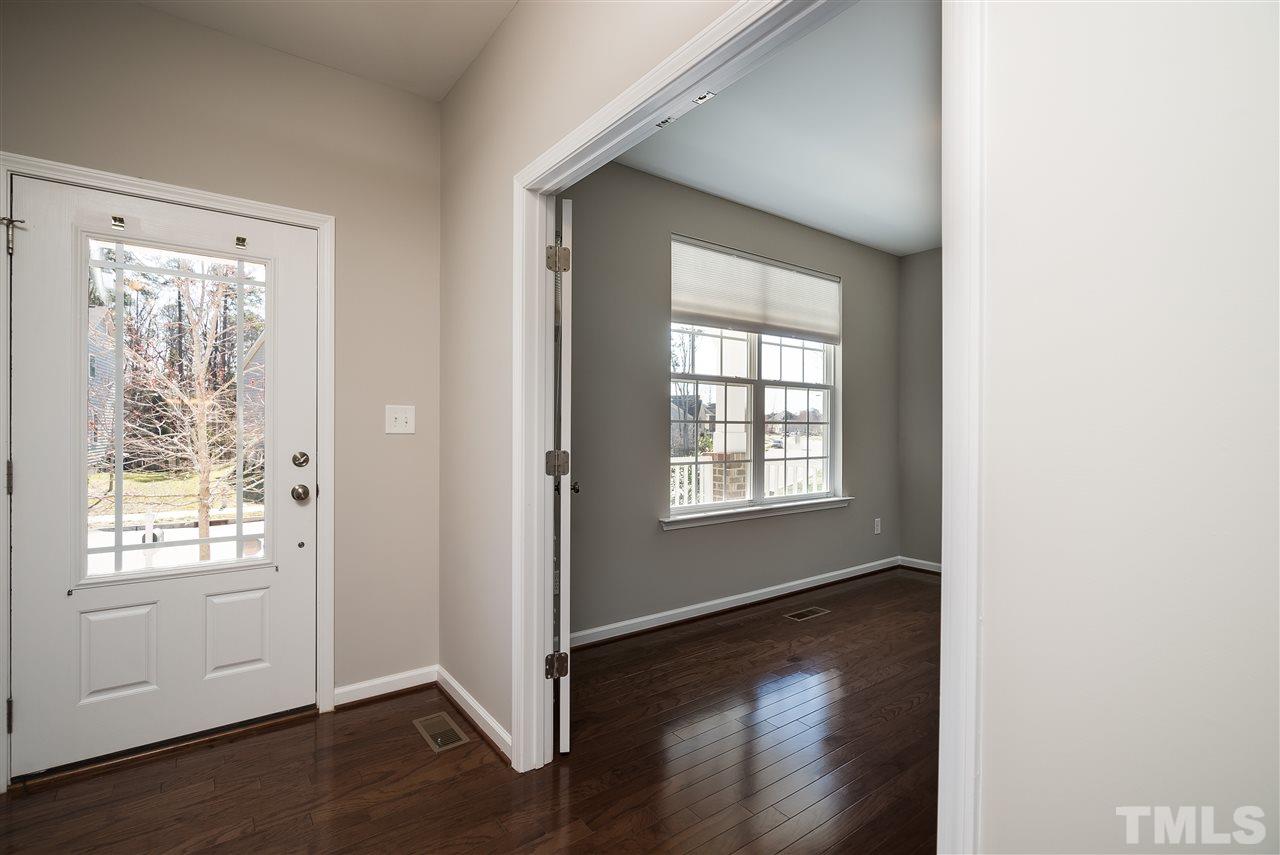 1004 Lakeview Road Durham, NC 27712 - Photo 2 of 25 a view of an empty room with wooden floor and a window