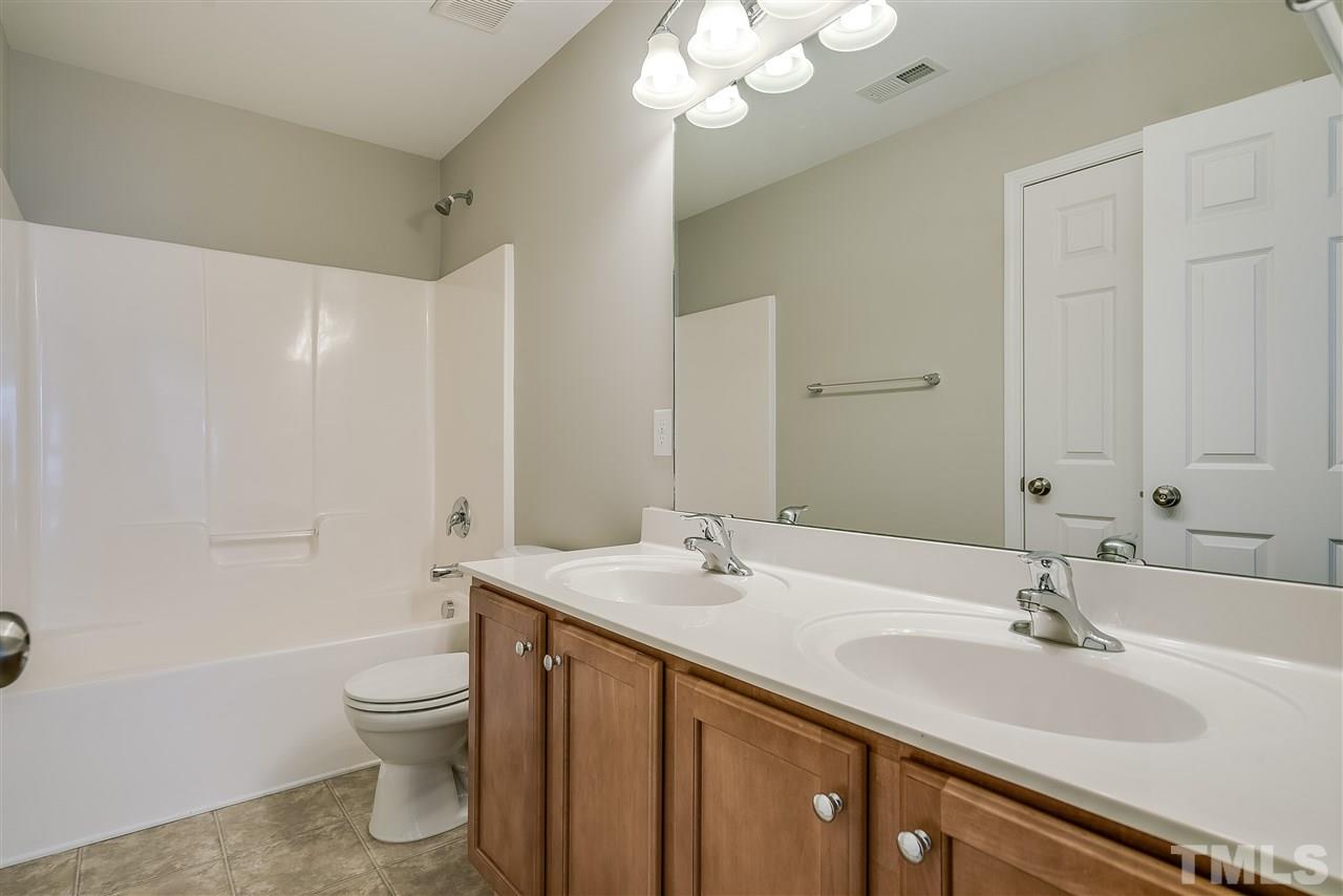 1004 Lakeview Road Durham, NC 27712 - Photo 20 of 25 a bathroom with a sink a toilet and shower