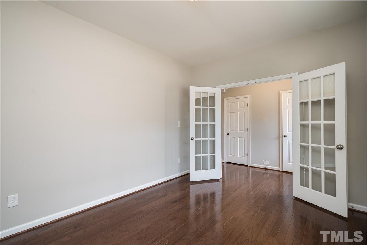 1004 Lakeview Road Durham, NC 27712 - Photo 4 of 25 an empty room with wooden floor and windows