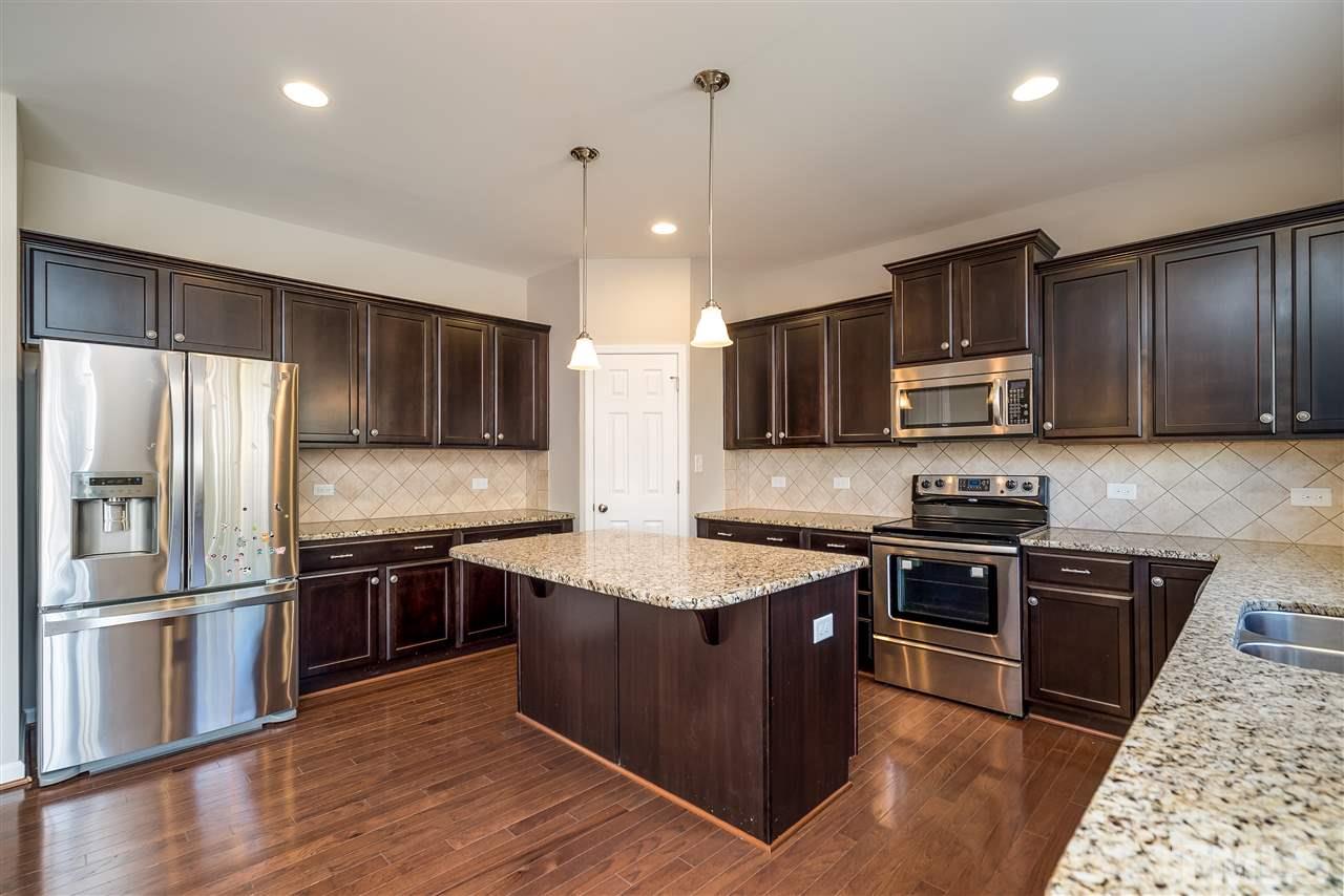 1004 Lakeview Road Durham, NC 27712 - Photo 8 of 25 a kitchen with stainless steel appliances granite countertop a sink stove and refrigerator