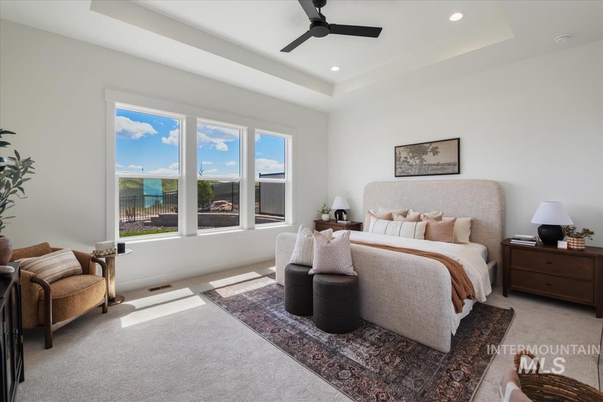 7615 Brown Way Eagle, ID 83714 - Photo 23 of 43 Spacious bedroom featuring a tray ceiling with recessed lighting and a ceiling fan