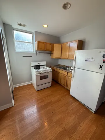 a kitchen with wooden cabinets and stainless steel appliances