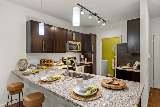 a kitchen with a dining table and chairs