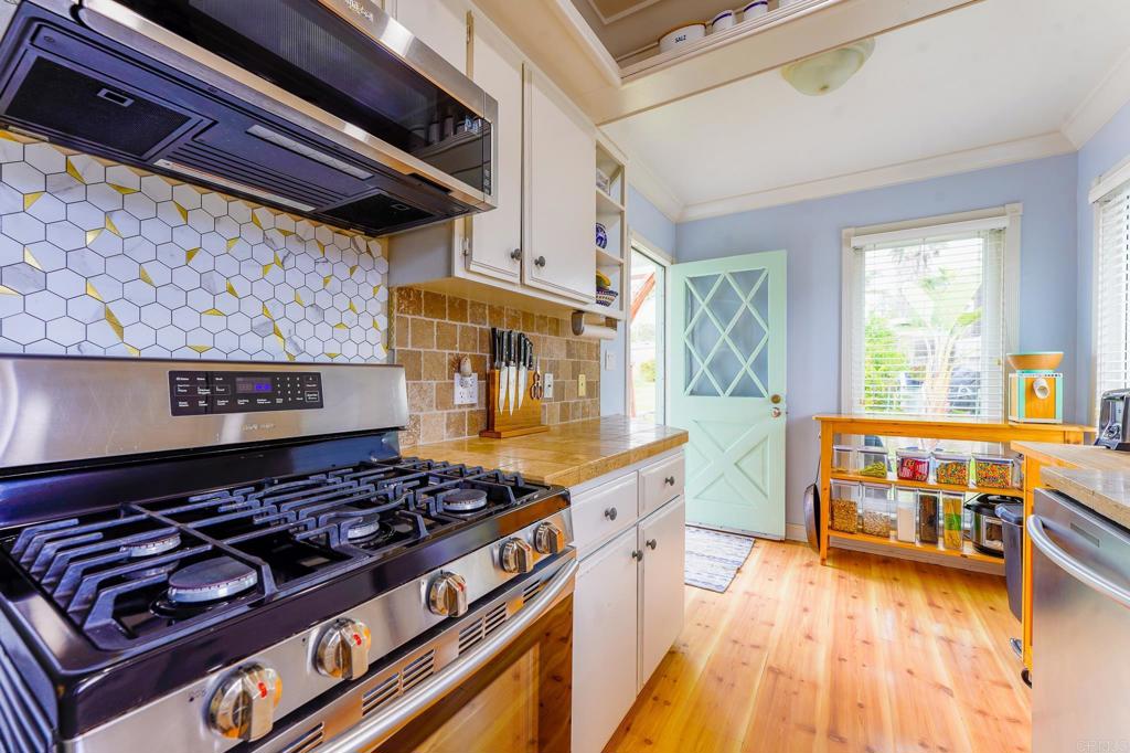 1043 Aloha Drive Encinitas, CA 92024 - Photo 16 of 27 a kitchen with a stove and wooden floor
